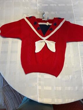 Red Sailor-Style Knit Sweater with Cream Accent Bow and Star